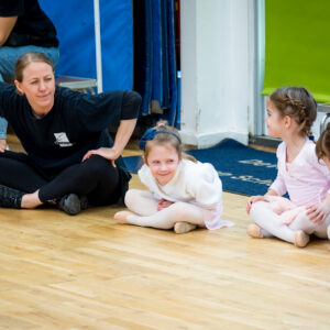 An image of students and an educator engaging in a indoor activity at Devonshire House School, an independent pre-prep and prep school based in London.
